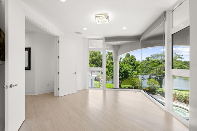9138 Great Heron Cir, Orlando, FL 32836 - spare room with healthy amount of natural light, light wood-style flooring, a water view, and recessed lighting