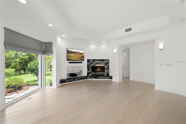 9138 Great Heron Cir, Orlando, FL 32836 - living room featuring a raised ceiling, light wood-style flooring, recessed lighting, and a premium fireplace
