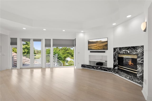 9138 Great Heron Cir, Orlando, FL 32836 - unfurnished living room featuring a premium fireplace, recessed lighting, and wood finished floors