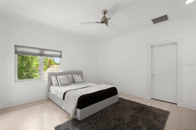 9138 Great Heron Cir, Orlando, FL 32836 - bedroom with light wood finished floors and ceiling fan