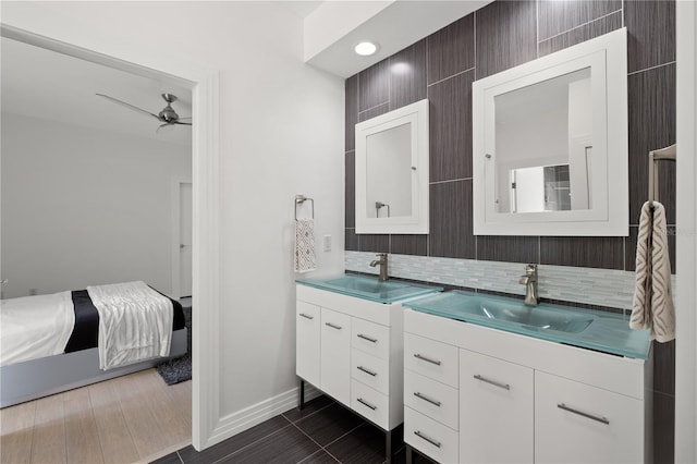 9138 Great Heron Cir, Orlando, FL 32836 - full bathroom with double vanity, a ceiling fan, and decorative backsplash