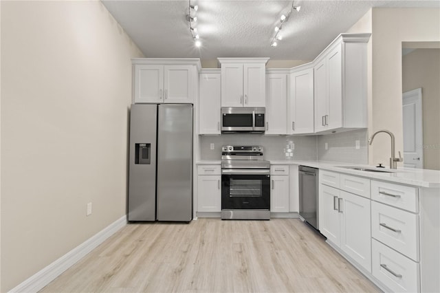 3672 Rollin O Ln, Apopka, FL 32703 - kitchen with stainless steel appliances, a sink, decorative backsplash, light countertops, and light wood-style floors