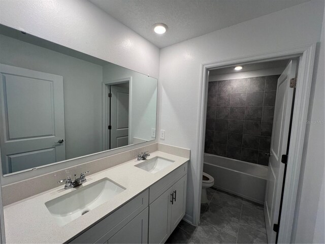 930 Cattleman St, Winter Haven, FL 33881 - bathroom with double vanity, toilet, tile patterned floors, a textured ceiling, and bathtub / shower combination