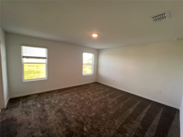 930 Cattleman St, Winter Haven, FL 33881 - spare room with dark colored carpet, healthy amount of natural light, and baseboards