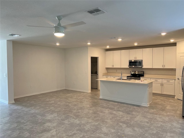 930 Cattleman St, Winter Haven, FL 33881 - kitchen featuring stainless steel microwave, electric stove, ceiling fan, a sink, and baseboards