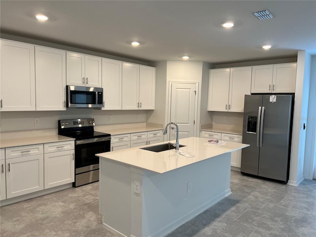 930 Cattleman St, Winter Haven, FL 33881 - kitchen with stainless steel appliances, a sink, white cabinetry, light countertops, and recessed lighting