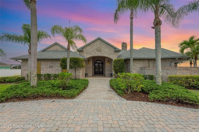 1175 Tuckaway Dr, Rockledge, FL 32955 - view of front of house featuring french doors and brick siding