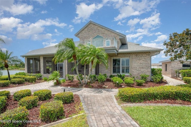 1175 Tuckaway Dr, Rockledge, FL 32955 - view of front facade featuring a balcony, a sunroom, and brick siding