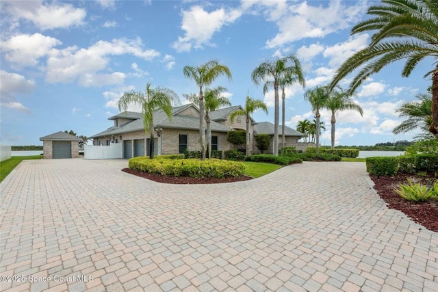 1175 Tuckaway Dr, Rockledge, FL 32955 - view of front facade with driveway, a garage, and stone siding