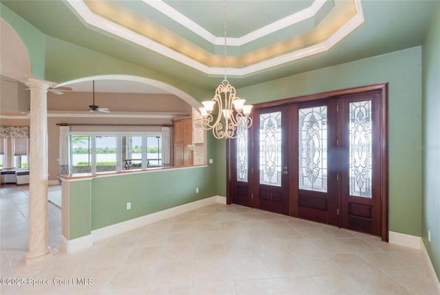 1175 Tuckaway Dr, Rockledge, FL 32955 - foyer featuring decorative columns, light tile patterned floors, a raised ceiling, a chandelier, and baseboards