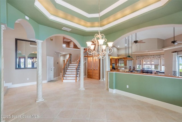 1175 Tuckaway Dr, Rockledge, FL 32955 - kitchen with ceiling fan, a towering ceiling, tile patterned floors, a raised ceiling, and decorative light fixtures