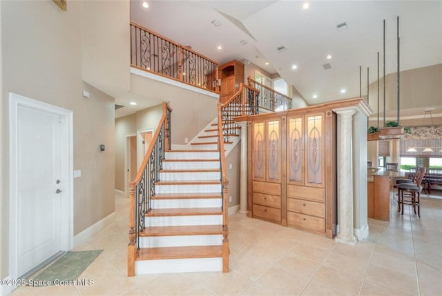 1175 Tuckaway Dr, Rockledge, FL 32955 - stairway featuring high vaulted ceiling, ornate columns, recessed lighting, tile patterned flooring, and baseboards