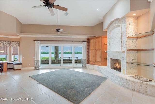 1175 Tuckaway Dr, Rockledge, FL 32955 - unfurnished living room with ceiling fan, light tile patterned floors, a large fireplace, baseboards, and a high ceiling