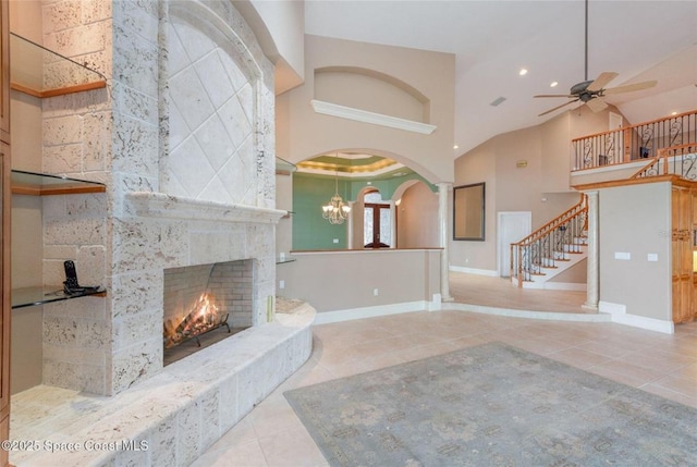 1175 Tuckaway Dr, Rockledge, FL 32955 - unfurnished living room with tile patterned flooring, a fireplace, baseboards, stairway, and a ceiling fan