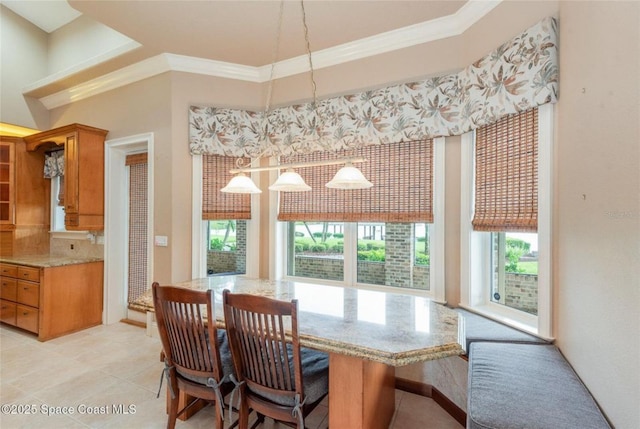 1175 Tuckaway Dr, Rockledge, FL 32955 - dining area with healthy amount of natural light and crown molding