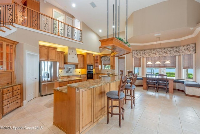 1175 Tuckaway Dr, Rockledge, FL 32955 - kitchen featuring stainless steel refrigerator with ice dispenser, high vaulted ceiling, light tile patterned floors, premium range hood, and light stone counters