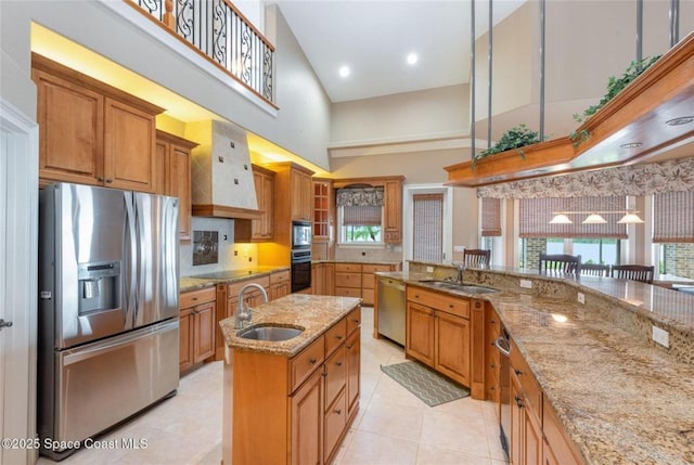 1175 Tuckaway Dr, Rockledge, FL 32955 - kitchen with black appliances, a sink, a high ceiling, brown cabinets, and light stone countertops