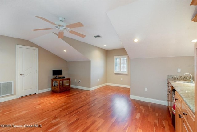 1175 Tuckaway Dr, Rockledge, FL 32955 - additional living space with a sink, lofted ceiling, a ceiling fan, light wood finished floors, and baseboards