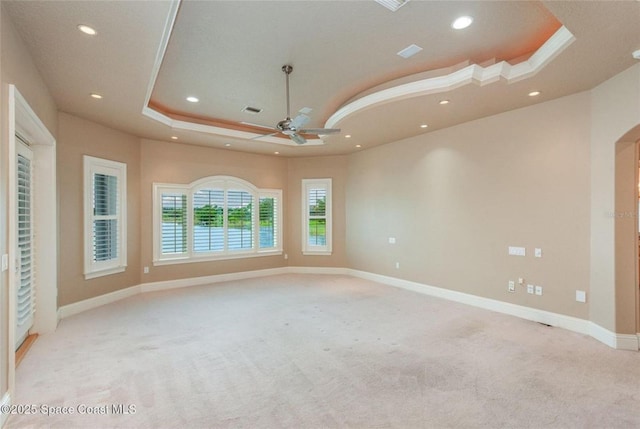 1175 Tuckaway Dr, Rockledge, FL 32955 - empty room featuring light colored carpet, a ceiling fan, a tray ceiling, recessed lighting, and baseboards