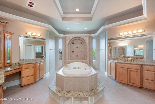 1175 Tuckaway Dr, Rockledge, FL 32955 - bathroom featuring a tub with jets, tile patterned floors, a tray ceiling, vanity, and recessed lighting