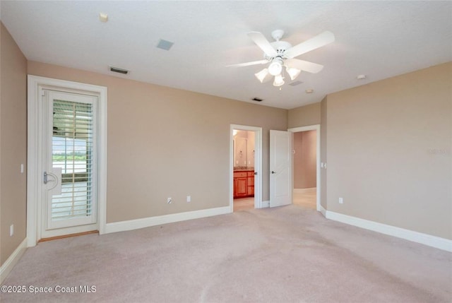 1175 Tuckaway Dr, Rockledge, FL 32955 - unfurnished bedroom featuring light carpet, baseboards, access to exterior, and connected bathroom