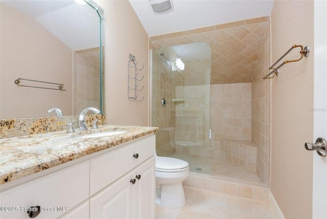 1175 Tuckaway Dr, Rockledge, FL 32955 - bathroom with toilet, vanity, tiled shower, and tile patterned flooring