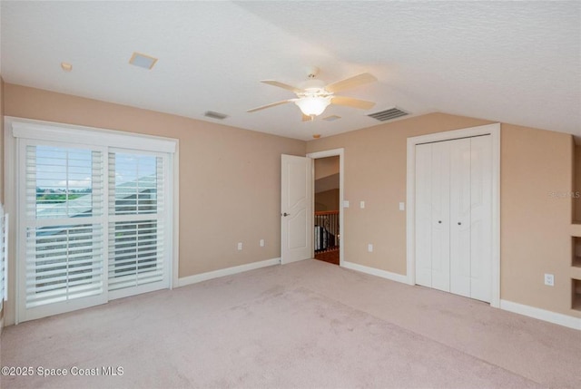 1175 Tuckaway Dr, Rockledge, FL 32955 - unfurnished bedroom with carpet flooring, baseboards, lofted ceiling, a ceiling fan, and a closet