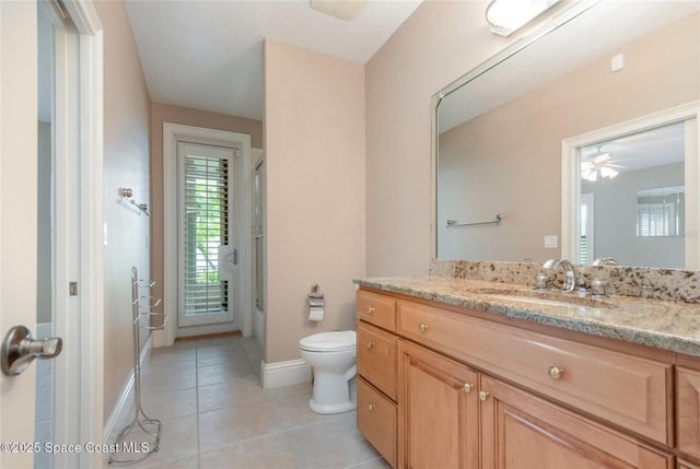 1175 Tuckaway Dr, Rockledge, FL 32955 - full bath with vanity, toilet, tile patterned flooring, bath / shower combo with glass door, and baseboards