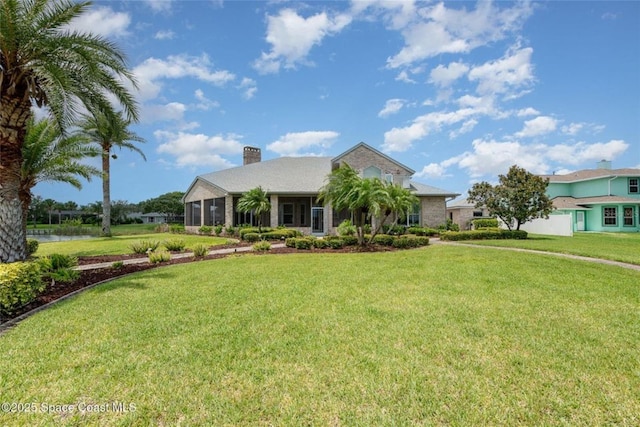 1175 Tuckaway Dr, Rockledge, FL 32955 - view of front of house with a chimney and a front yard