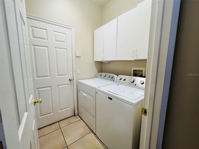 830 Moonlit Ln, Casselberry, FL 32707 - laundry room featuring washer and dryer, cabinet space, and light tile patterned floors