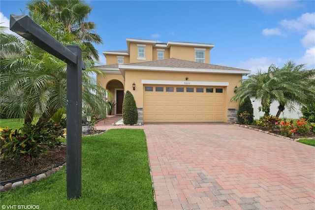 2659 Magpie Way, Sanford, FL 32773 - view of front facade with stucco siding, an attached garage, decorative driveway, and a front yard
