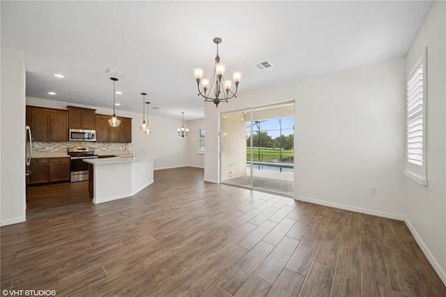 2659 Magpie Way, Sanford, FL 32773 - unfurnished living room featuring a chandelier, dark wood-style flooring, baseboards, recessed lighting, and a sink