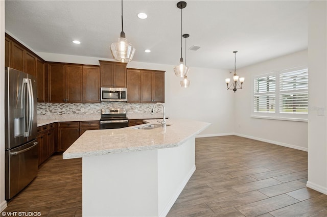 2659 Magpie Way, Sanford, FL 32773 - kitchen with stainless steel appliances, a sink, backsplash, dark wood finished floors, and recessed lighting