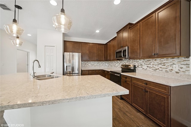 2659 Magpie Way, Sanford, FL 32773 - kitchen with appliances with stainless steel finishes, a sink, dark wood-style floors, decorative backsplash, and recessed lighting