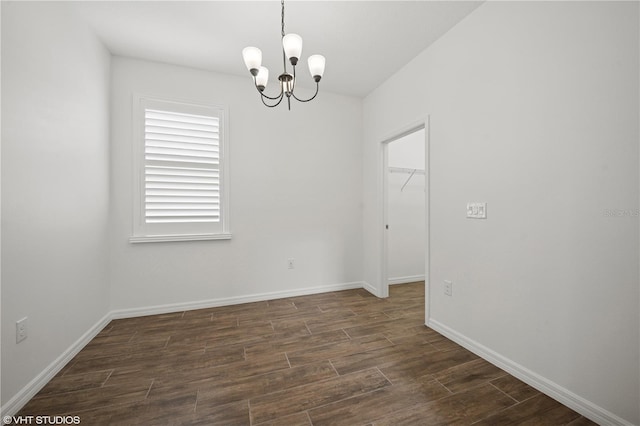 2659 Magpie Way, Sanford, FL 32773 - spare room featuring a chandelier, dark wood-type flooring, and baseboards