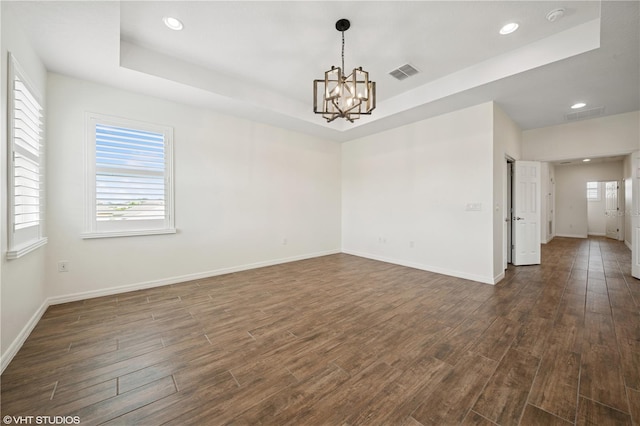 2659 Magpie Way, Sanford, FL 32773 - unfurnished room featuring dark wood finished floors, recessed lighting, a chandelier, baseboards, and a raised ceiling