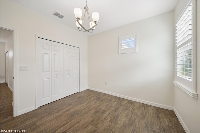 2659 Magpie Way, Sanford, FL 32773 - unfurnished bedroom with a chandelier, dark wood-style flooring, a closet, and baseboards
