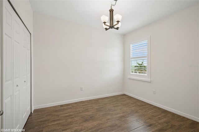 2659 Magpie Way, Sanford, FL 32773 - unfurnished bedroom with a chandelier, a closet, dark wood finished floors, and baseboards