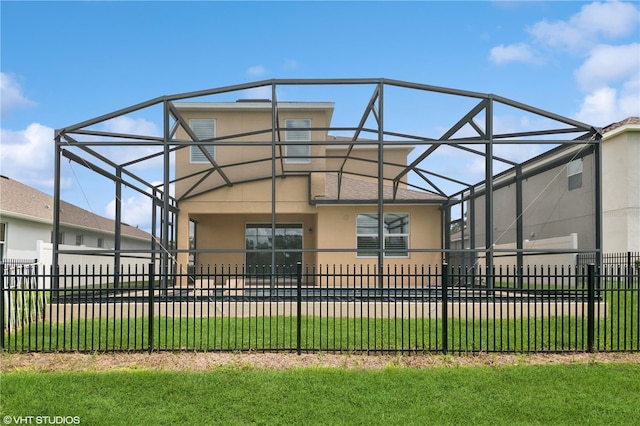 2659 Magpie Way, Sanford, FL 32773 - rear view of property featuring stucco siding and glass enclosure