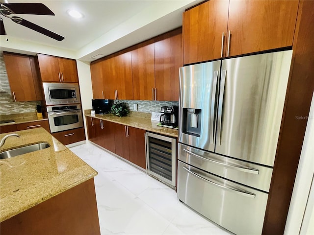 1925 S Atlantic Ave Unit 411, Daytona Beach, FL 32118 - kitchen with stainless steel appliances, wine cooler, a sink, a ceiling fan, and tasteful backsplash