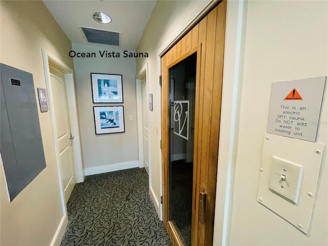 1925 S Atlantic Ave Unit 411, Daytona Beach, FL 32118 - hall featuring baseboards, electric panel, and dark colored carpet
