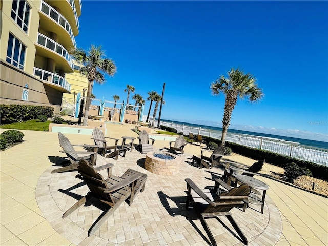 1925 S Atlantic Ave Unit 411, Daytona Beach, FL 32118 - view of patio featuring a fire pit and a water view