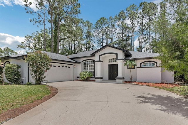 17 Waterford Pl, Palm Coast, FL 32164 - view of front of property featuring an attached garage, driveway, stucco siding, and roof with shingles