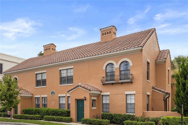 730 Siena Palm Dr Unit 201, Celebration, FL 34747 - view of front of home featuring a chimney, a tile roof, and stucco siding