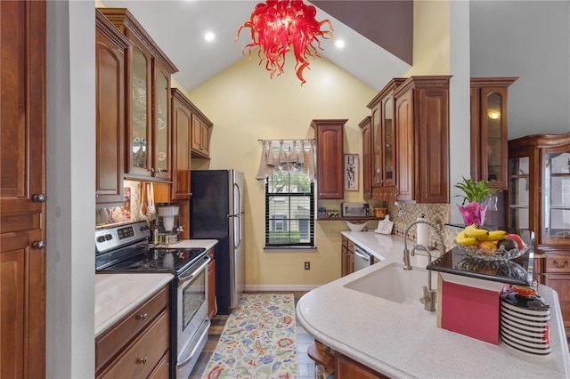 730 Siena Palm Dr Unit 201, Celebration, FL 34747 - kitchen with stainless steel appliances, light countertops, glass insert cabinets, high vaulted ceiling, and recessed lighting