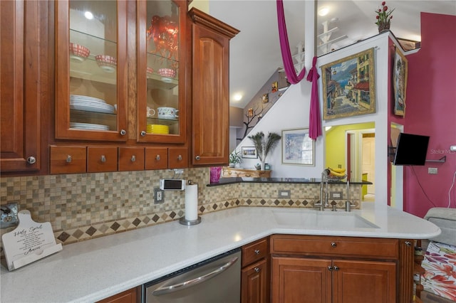 730 Siena Palm Dr Unit 201, Celebration, FL 34747 - kitchen featuring a sink, stainless steel dishwasher, tasteful backsplash, light countertops, and glass insert cabinets
