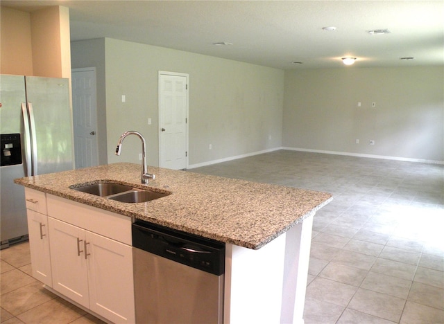17305 Cagan Crossings Blvd, Clermont, FL 34714 - kitchen with appliances with stainless steel finishes, a sink, a kitchen island with sink, white cabinetry, and light stone counters