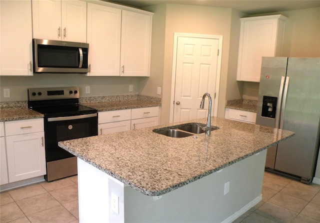 17305 Cagan Crossings Blvd, Clermont, FL 34714 - kitchen with appliances with stainless steel finishes, a sink, light tile patterned floors, and white cabinetry