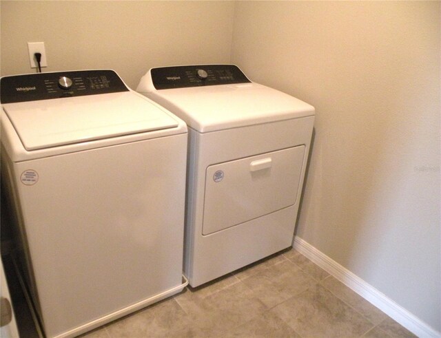 17305 Cagan Crossings Blvd, Clermont, FL 34714 - washroom with washer and dryer, baseboards, and light tile patterned floors
