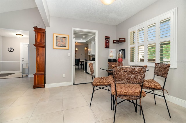 7058 Archwood Dr, Orlando, FL 32819 - dining room with a textured ceiling, baseboards, and light tile patterned flooring